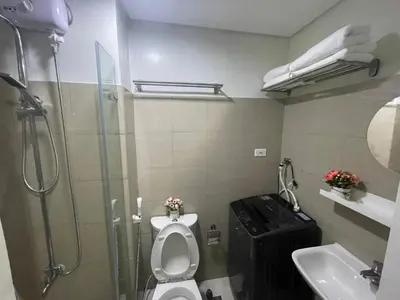 a bathroom with a shower and a toilet and a sink at MOA Staycation at Shore 2 in Manila