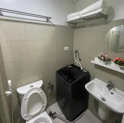 a bathroom with a white toilet and a sink at MOA Staycation at Shore 2 in Manila