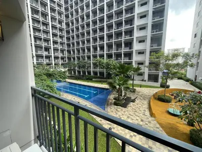 a balcony view of a building with a swimming pool at MOA Staycation at Shore 2 in Manila