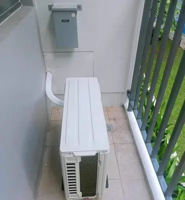 a white bench sitting on the side of a building at MOA Staycation at Shore 2 in Manila