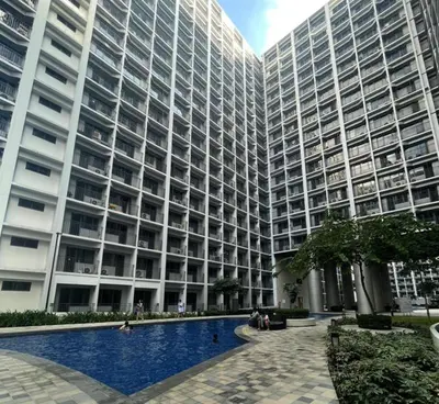 a large building with a swimming pool in front of it at MOA Staycation at Shore 2 in Manila