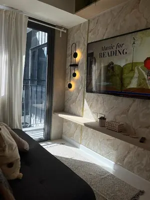a bedroom with a bed and a window with a sign at New Luxury Condo in Mall of Asia and near Manila Airport in Manila