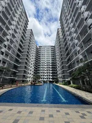 two large apartment buildings with a pool in the middle at SHORE 3 RESIDENCES TOWER 2 in Manila