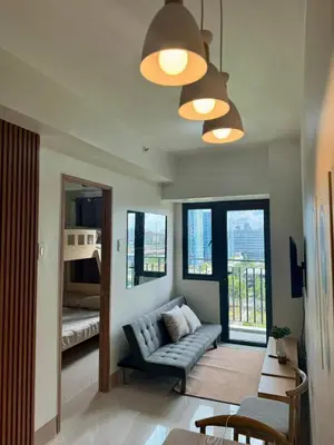 a living room with a couch and a bunk bed at SHORE 3 RESIDENCES TOWER 2 in Manila