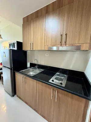 a kitchen with a sink and a refrigerator at SHORE 3 RESIDENCES TOWER 2 in Manila