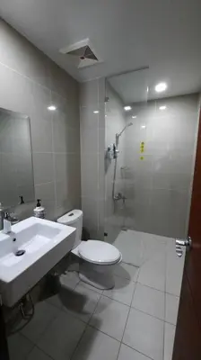 a bathroom with a toilet and a sink and a shower at Bonifacio global city one uptown residence-2 Bedroom in Manila
