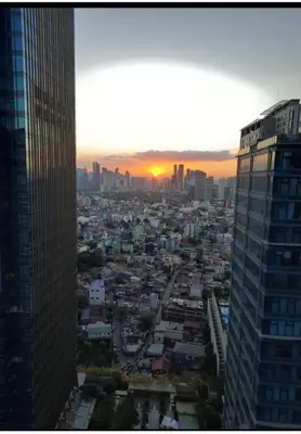 a view of a city at sunset from a skyscraper at Bonifacio global city one uptown residence-2 Bedroom in Manila