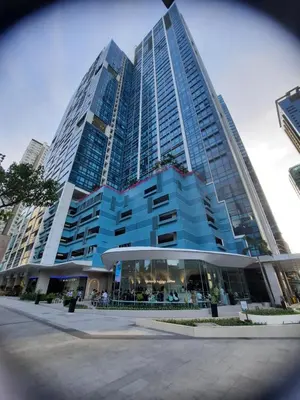 a large blue building with people in front of it at Bonifacio global city one uptown residence-2 Bedroom in Manila
