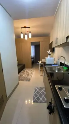 a kitchen with a sink and a counter top at Shore Residence D22 shortwalk MOA Balconypoolview in Manila