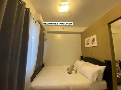 a small room with a bed and a window at Shore Residence D22 shortwalk MOA Balconypoolview in Manila