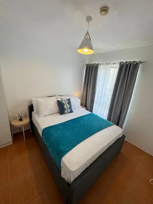 a bedroom with a large bed with a window at Modern Oasis: Pool + Netflix in Manila