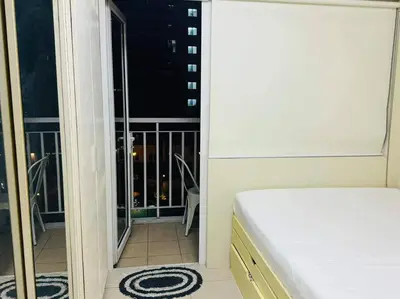 a bedroom with a bed and a view of a balcony at SHELL RESIDENCE C22 Shortwalk MOA Balcony poolview in Manila