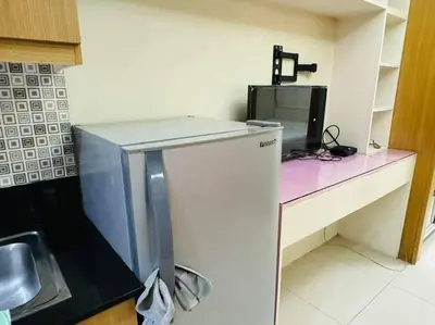 a small kitchen with a counter with a microwave at SHELL RESIDENCE C22 Shortwalk MOA Balcony poolview in Manila