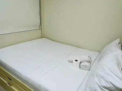 a bed with two rolls of toilet paper on it at SHELL RESIDENCE C22 Shortwalk MOA Balcony poolview in Manila
