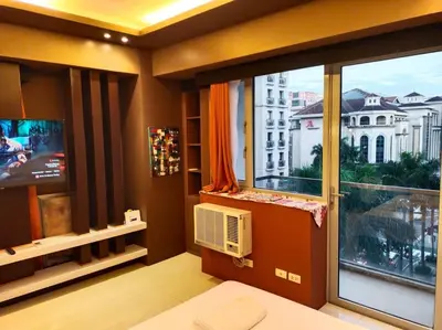 a room with a large window with a view of a building at Modern Condo Infront of NAIA T3 (Virluxe Suites) in Manila