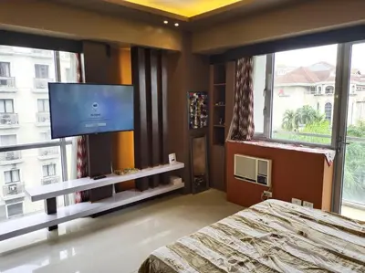 a bedroom with a bed and a flat screen tv at Modern Condo Infront of NAIA T3 (Virluxe Suites) in Manila