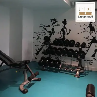 a room with a gym with a rack of weights at Muji KLTower Makati - Greenbelt - with Pool Access in Manila