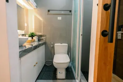a bathroom with a toilet and a sink at Frost at Air Residences Makati in Manila