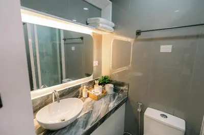 a bathroom with a sink and a toilet at Frost at Air Residences Makati in Manila
