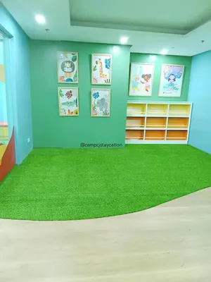 a room with a green rug on the floor at CAMP CJ Staycation A Cozy, Modern Studio near BGC & MRT Boni, Perfect for Relaxing City Getaways in Manila