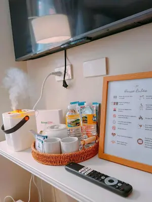 a shelf with a tray of food and a remote control at CAMP CJ Staycation A Cozy, Modern Studio near BGC & MRT Boni, Perfect for Relaxing City Getaways in Manila