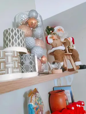 a shelf with christmas ornaments on it at CAMP CJ Staycation A Cozy, Modern Studio near BGC & MRT Boni, Perfect for Relaxing City Getaways in Manila