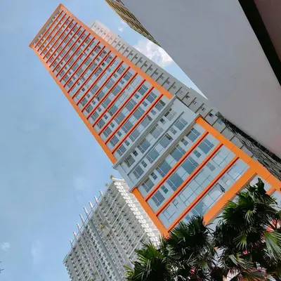 a large tall building with trees in front of it at CAMP CJ Staycation A Cozy, Modern Studio near BGC & MRT Boni, Perfect for Relaxing City Getaways in Manila