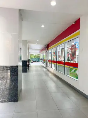 an empty hallway of a building with a store at Madison Place at Sea Residences powered by Cocotel in Manila