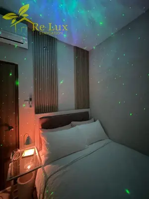 a bedroom with a bed with a star wall at Re Lux Staycation, NEAR NAIA in Manila