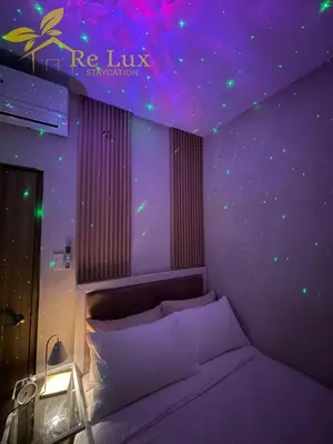 a bedroom with a bed with a starry ceiling at Re Lux Staycation, NEAR NAIA in Manila