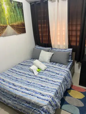 a bed with two pillows on it in a room at Pierrecondotel in Manila