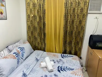 a bed with two pillows on it in a bedroom at Pierrecondotel in Manila