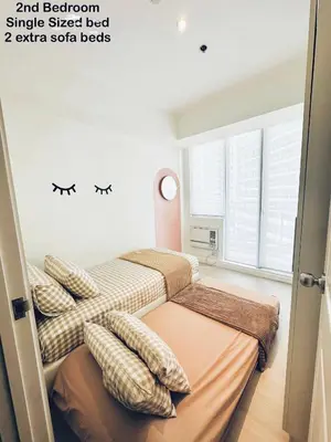 two beds in a room with two windows at Azure Urban Resort Residences Paranaque 2 Bedroom Unit in Manila