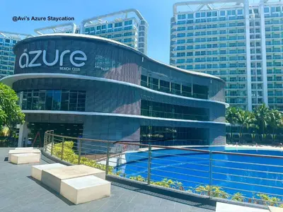 a building with a swimming pool in front of it at Azure Urban Resort Residences Paranaque 2 Bedroom Unit in Manila