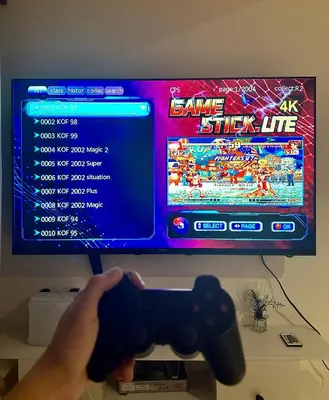 a person holding a video game controller in front of a tv at Azure Urban Resort Residences Paranaque 2 Bedroom Unit in Manila