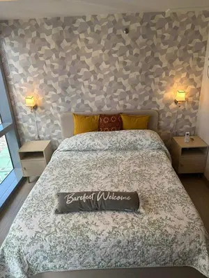 a bedroom with a bed with a sign on it at Angelheaven EGPLR in Manila