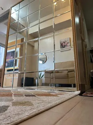 an open glass door with a couch in a room at Angelheaven EGPLR in Manila