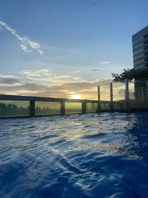 a pool on the roof of a building with the sunset at Angelheaven EGPLR in Manila