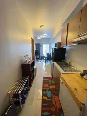 a small kitchen with a counter and a table at 8 Adriatico- 1 Bedroom Condo with Balcony in Ermita near US Embassy in Manila