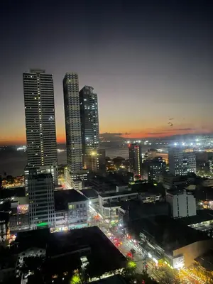 a city skyline with tall buildings at night at 8 Adriatico- 1 Bedroom Condo with Balcony in Ermita near US Embassy in Manila
