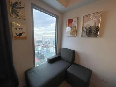 a room with a chair and a large window at 8 Adriatico- 1 Bedroom Condo with Balcony in Ermita near US Embassy in Manila