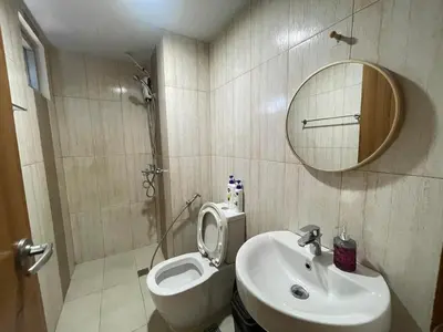 a bathroom with a toilet and a sink and a mirror at 8 Adriatico- 1 Bedroom Condo with Balcony in Ermita near US Embassy in Manila