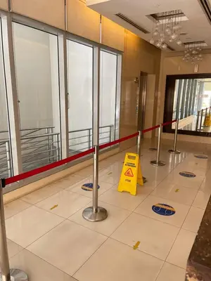 a lobby with a yellow sign on the floor at 8 Adriatico- 1 Bedroom Condo with Balcony in Ermita near US Embassy in Manila