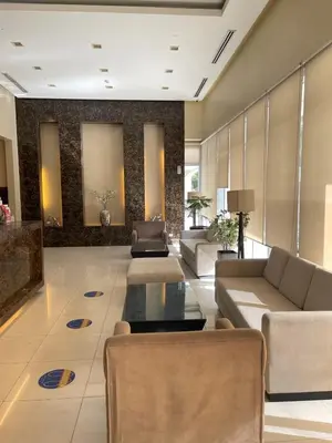 a living room with couches and a table at 8 Adriatico- 1 Bedroom Condo with Balcony in Ermita near US Embassy in Manila