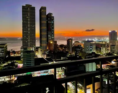 a view of a city skyline at night at 8 Adriatico- 1 Bedroom Condo with Balcony in Ermita near US Embassy in Manila