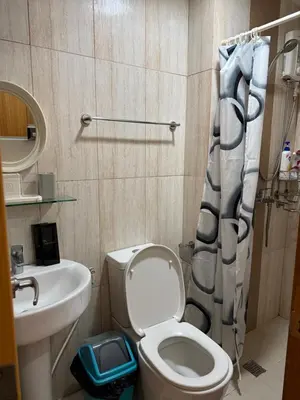 a small bathroom with a toilet and a sink at Modern Condo near St Lukes and US Embassy in Ermita Manila in Manila