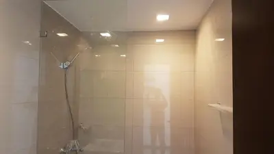 a bathroom with a shower with a glass door at 11B Tower 1 Viceroy Residences Mc Kinley Hill BGC in Manila