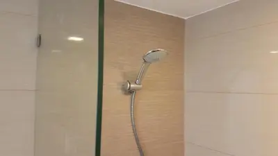 a shower with a shower head in a bathroom at 11C Tower 1 Viceroy Residences McKinley BGC in Manila