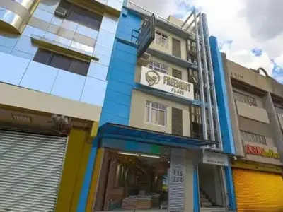 a building with a blue and yellow at Freemont Place in Manila