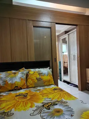 a bedroom with a bed with flowers on it at SHELL RESIDENCES MOA COMPLEX PASAY in Manila